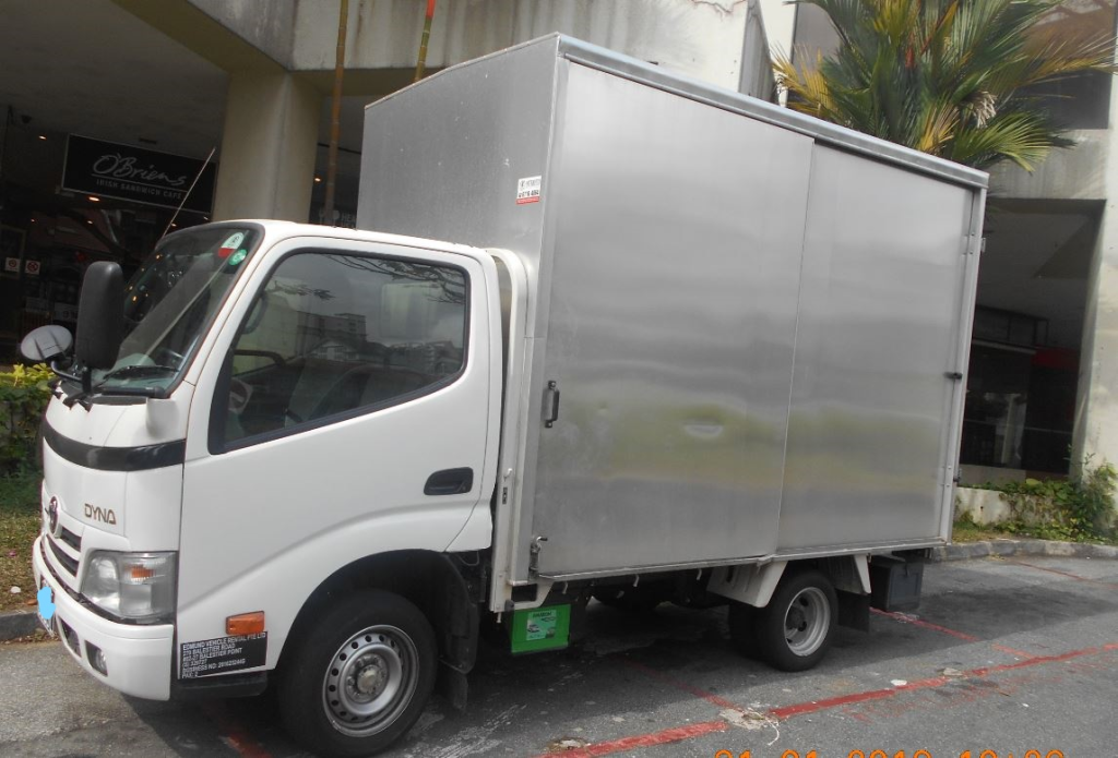Commercial rental lorry parked for fleet management operations in Singapore.